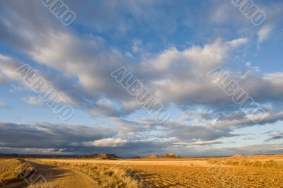 Lonely road under cloudy sky