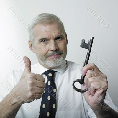 Matured man holding a key