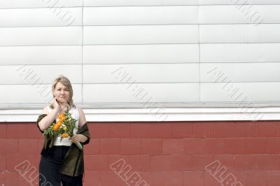 Women with bunch of flowers in city