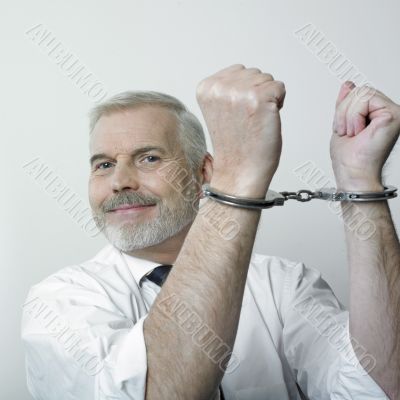 Happy handcuffed man