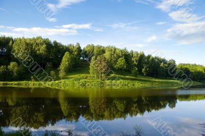 Blue reflection in river  at summer forest, Russia