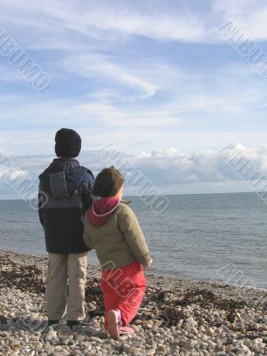 Boy and Girl on a Beach in Winter