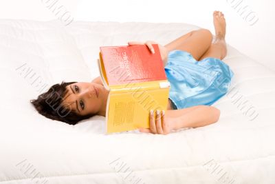 On my back reading a book