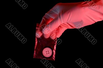 Hand in glove holding the evidence