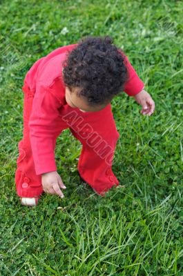 Baby playing on the grass