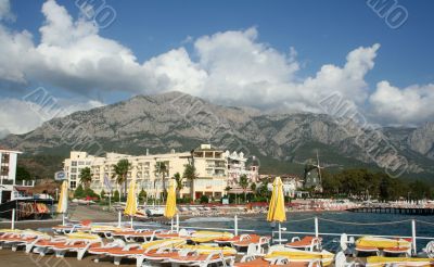 Beach with umbrellas in a kind of mountains