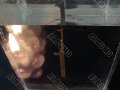 Needle in glass near candle