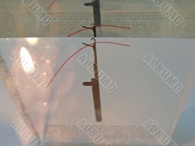 Needle in glass with candle