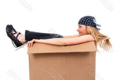 Girl sitting in a cardboard box