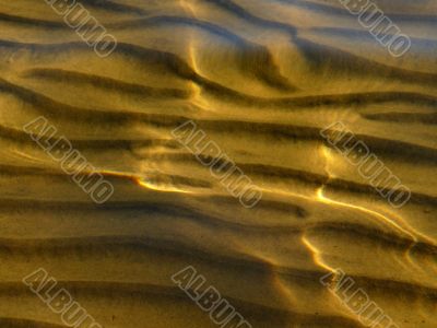 transparent water, waved sand & sun reflections