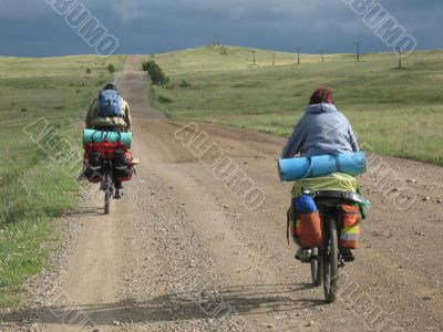 Couple of cyclists have a bicycle travel.
