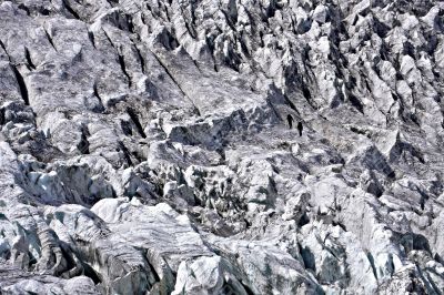 Two people trekking on a glacier