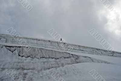  One man trekking  on a glacier.