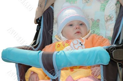 Little girl sit in carriage.