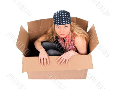 Cute girl sitting in a cardboard box