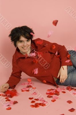 young beautiful woman surrounded by feathers