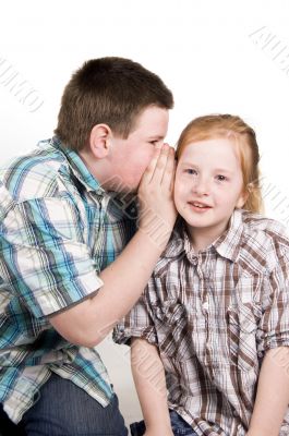 young boy is whispering