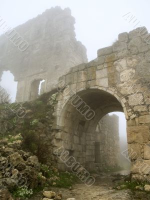 age-old stronghold gate arched mist morning