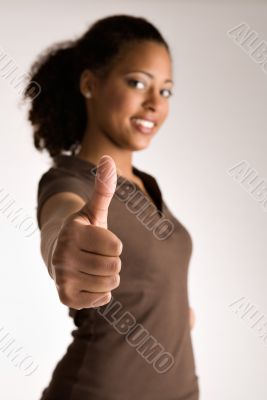 Woman is holding her thumb up