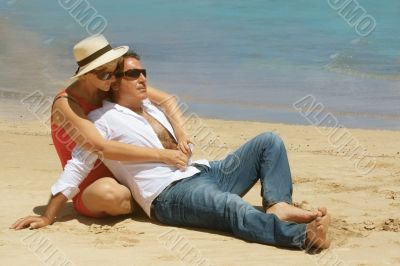 Romantic couple sitting on the beach