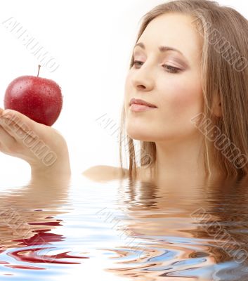 woman with red apple in water