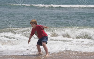 Boy Playing in the Ocean