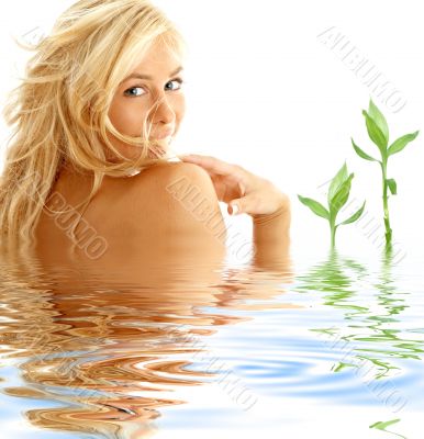 happy blonde in water with green plants