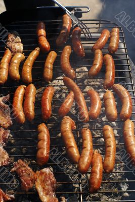 making nice juicy sausages on grill