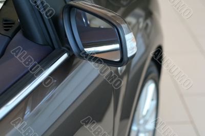 detail of new car in dealership showroom