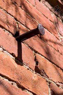 Old nail in a brick wall