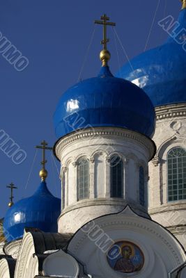 white-blue church onion domes against blue sky