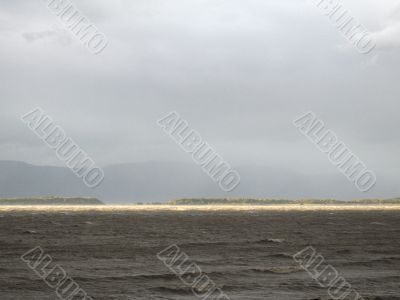 sun strip on a dark ocean