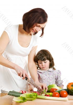 mother and daughter cooking at the kitchen