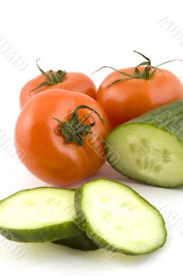 fresh tomatoes and a cucumber with slices