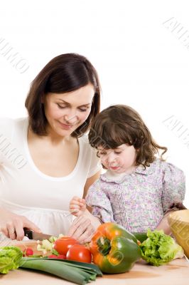 mother and daughter cooking at the kitchen