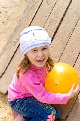child holds a ball
