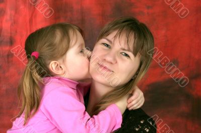 child kisses mother