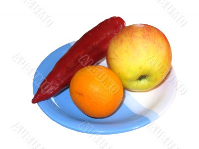 Orange, pepper and an apple on a plate