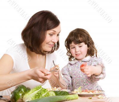 mother and daughter cooking at the kitchen