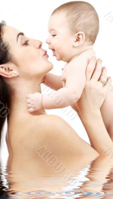 happy mother with baby in water