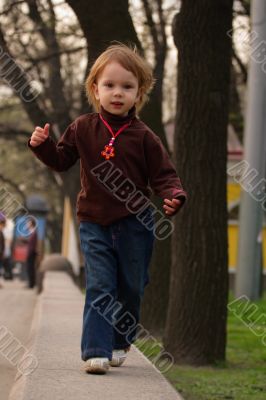 Little girl running to photographer or audience.