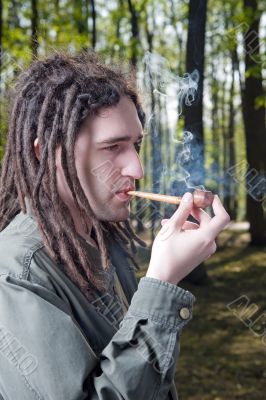 Young man with dreadlock hair.