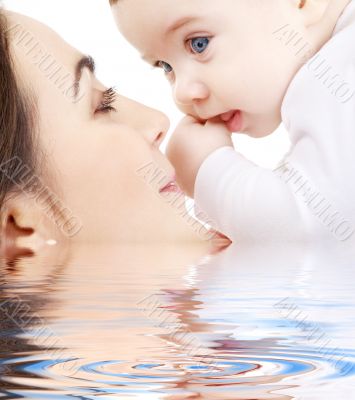 happy mother playing with baby boy in water 2