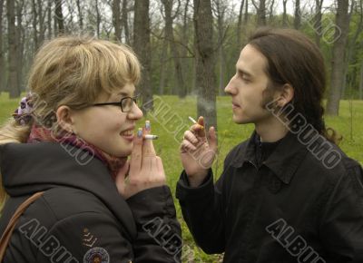Girl and man are smoking