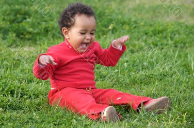 Baby playing on the grass