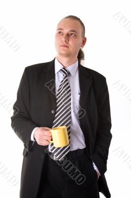 Serious looking businessman holding coffee cup