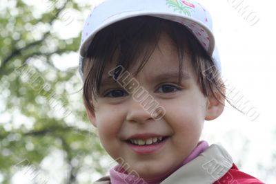 portrait of little girl walking in a park