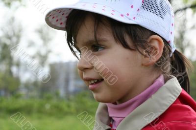 portrait of little girl walking in a park