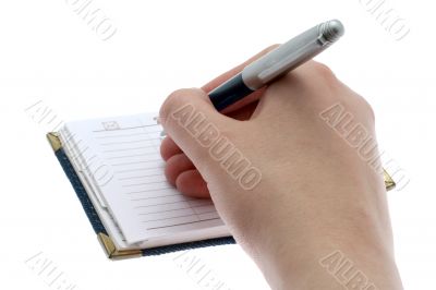 hand writes in a notebook