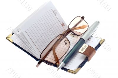 notebook, pen and glasses